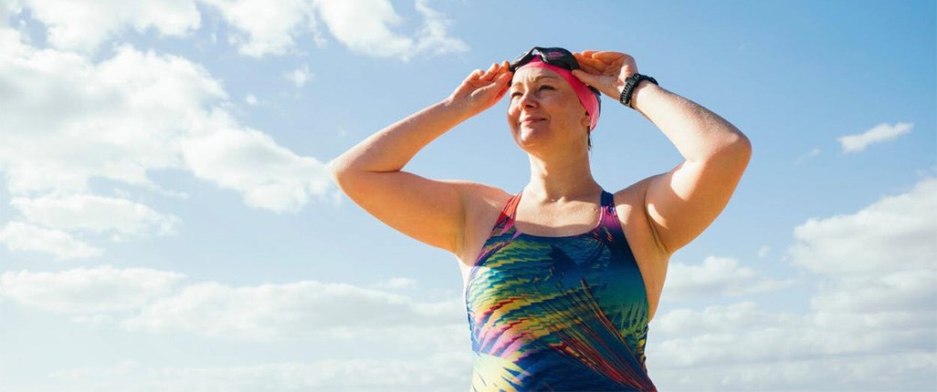 Woman preparing to go swimming as helps with chronic pain 