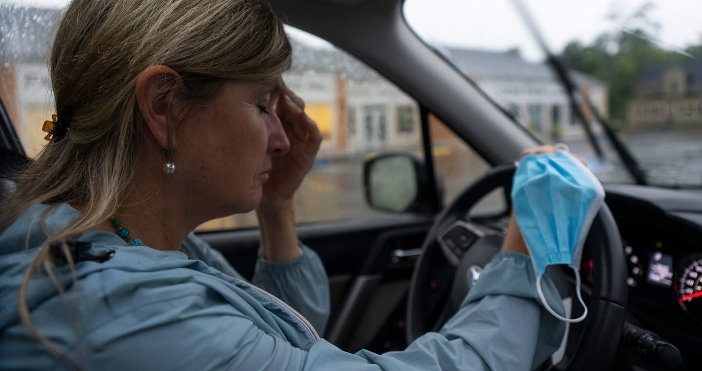 Nurse suffering from migraine symptoms as she prepares to drive home from work