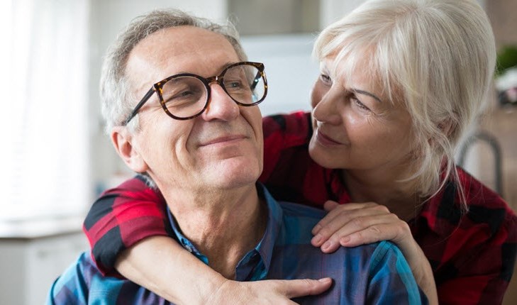 Senior man being hugged and comforted by his wife as he deals with worries about heart failure.