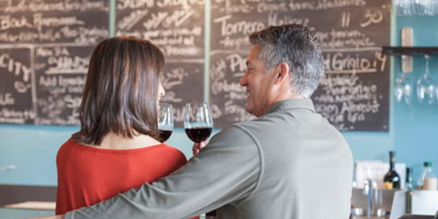 A couple at a wine bar on a date