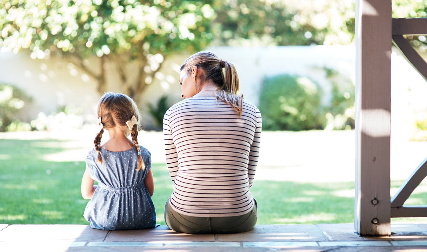 A mother and daughter sitting outside and having a discussion about ashtma