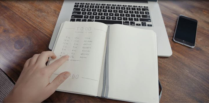 A woman living with ADHD checks her bullet journal to see what's next on her agenda.