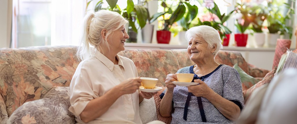 Daughter and family caregiver enjoying quality communication with her aging mother