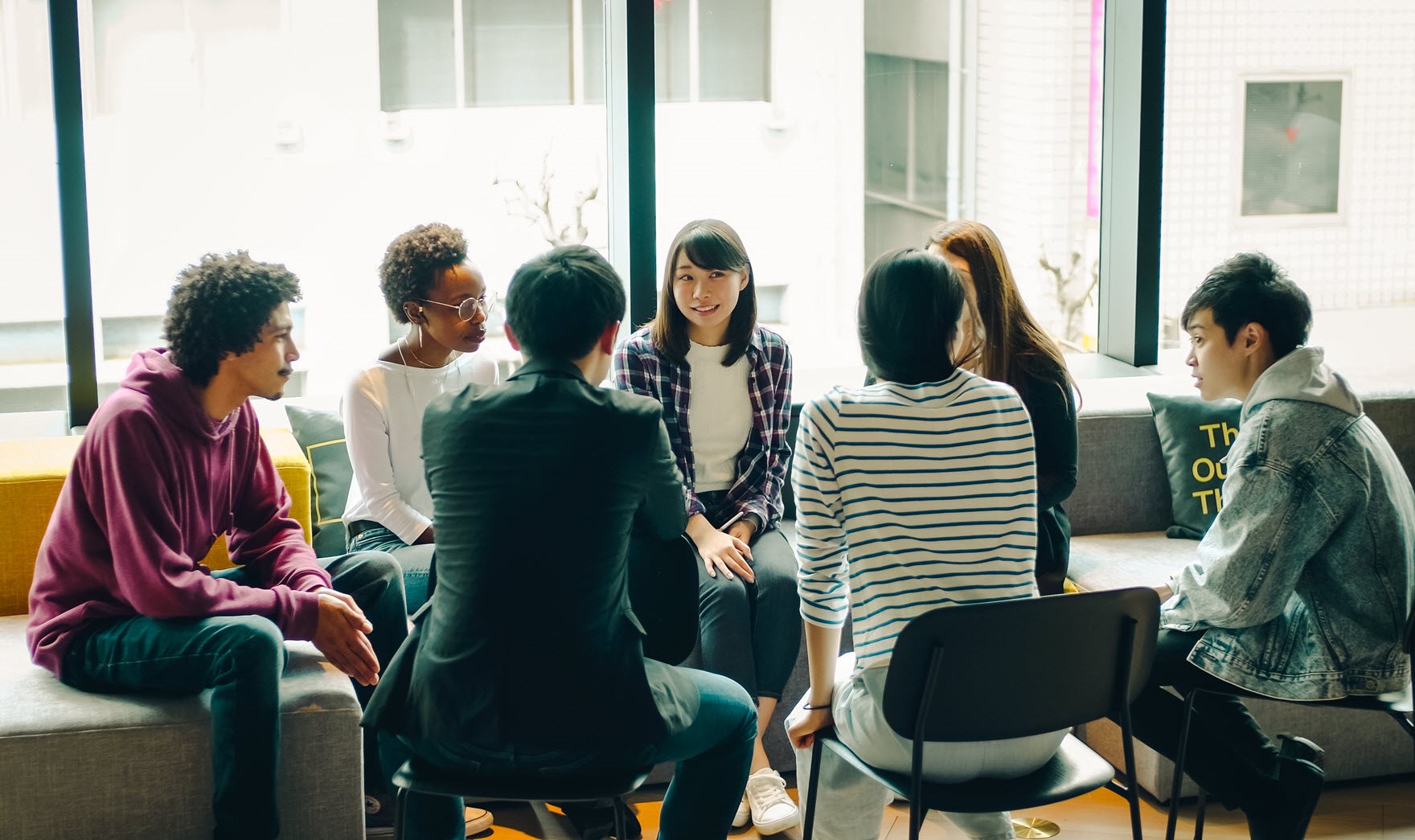 Group of young people sitting and talking