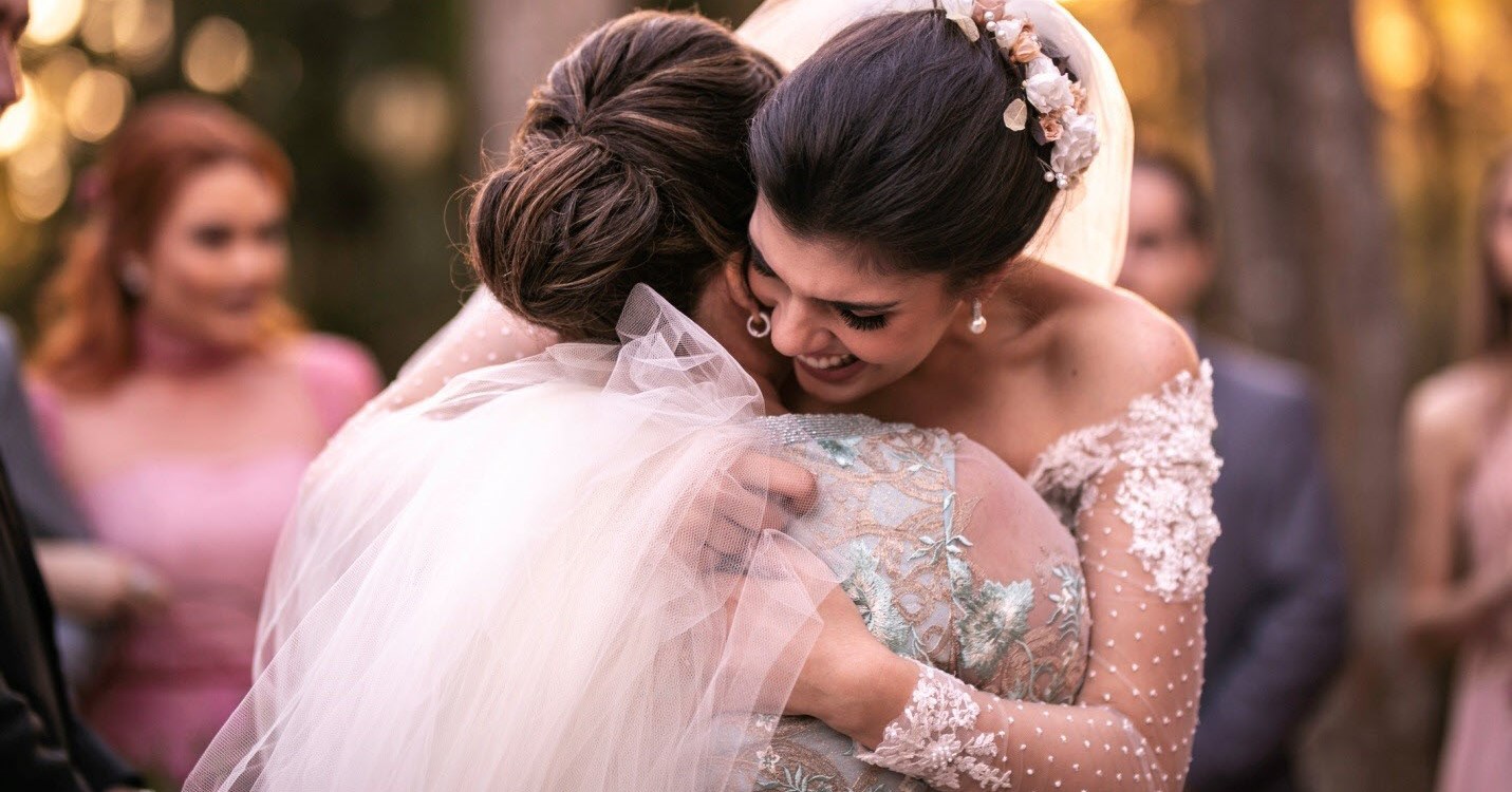 Mother with ADHD is proud as she hugs her newly married daughter