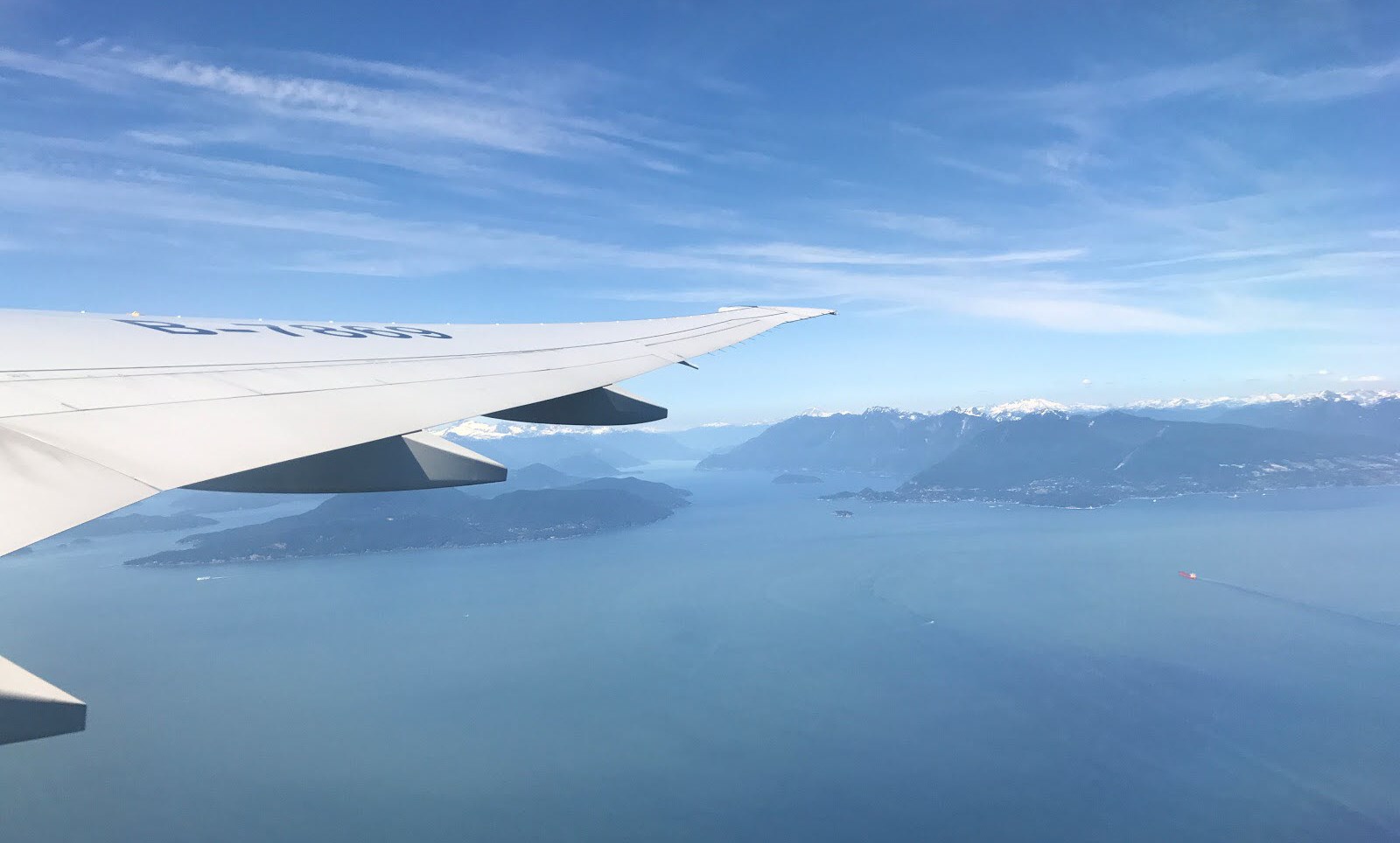 Passenger perspective of a plane wing over the sea as they travel