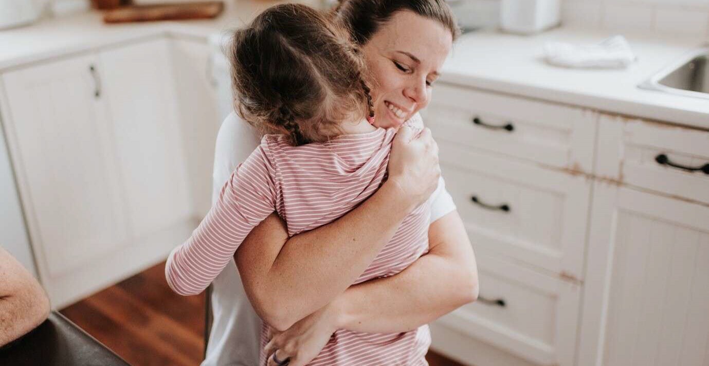 Relieved mother hugging her child to her chest