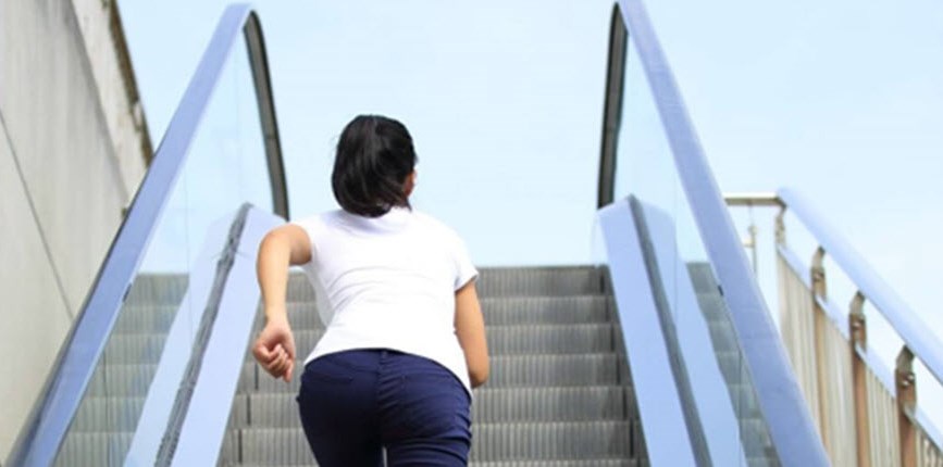 Woman running up escalator, symbolizing struggle communicating with HD