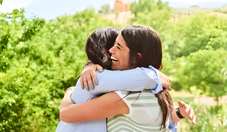 Two women hugging and celebrating their continued friendship