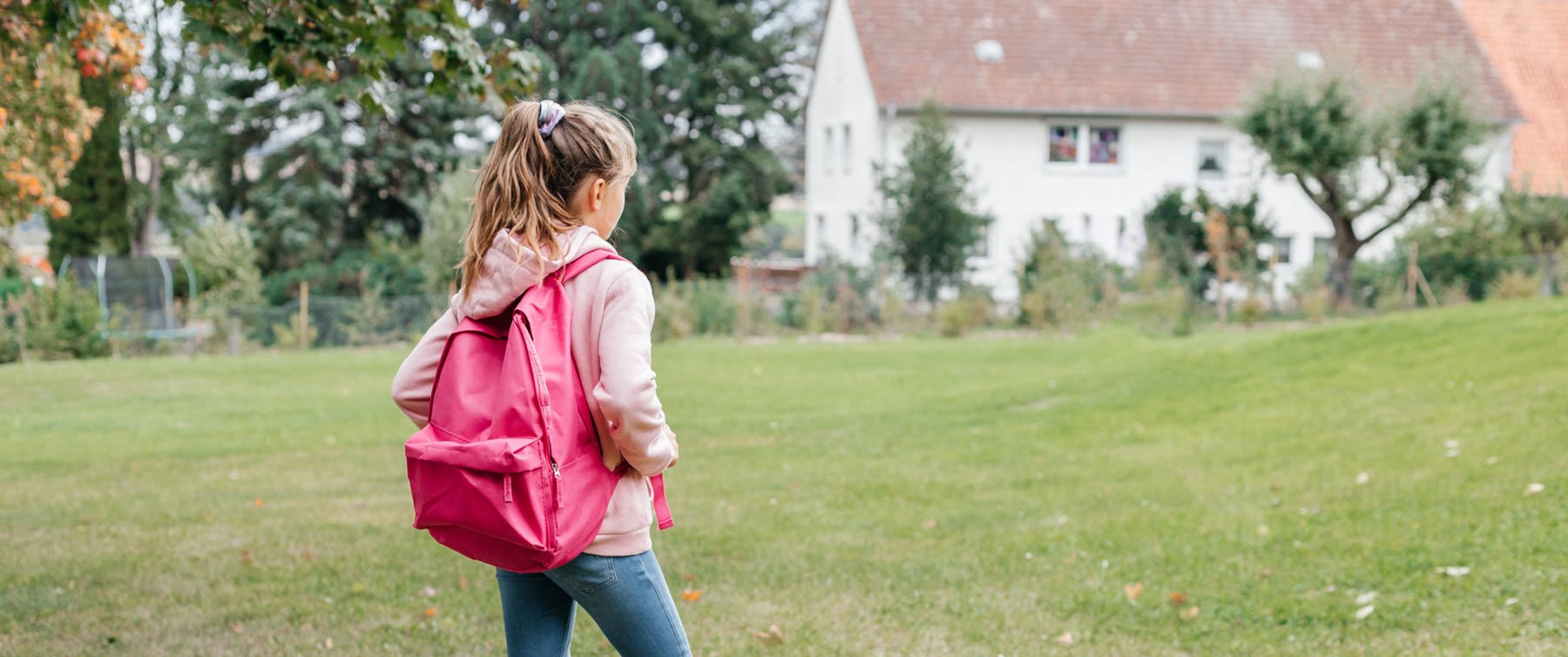 Young girl with backpack reluctant to walk to school due to mental health struggles and classmate teasing 