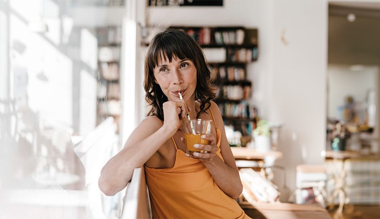 Woman with HD drinking with a straw to minimize the risk of choking 