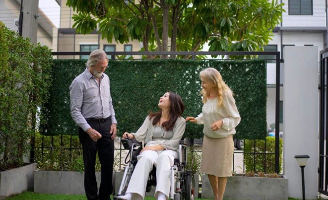 Woman in wheelchair with her family happy with less stressful life