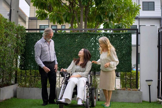 Woman in wheelchair with her family happy with less stressful life