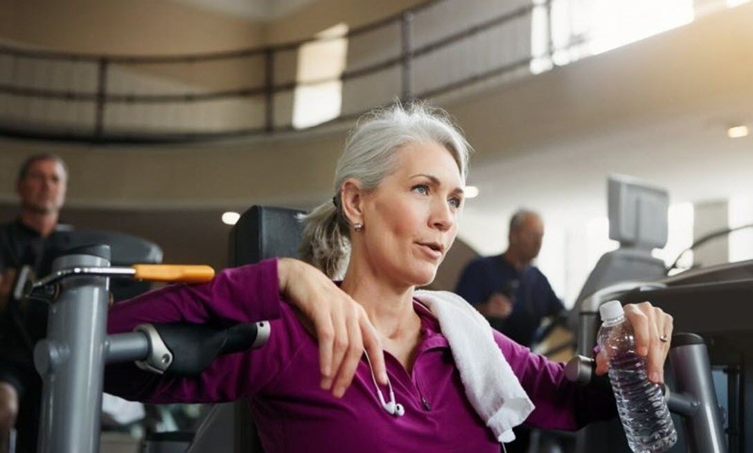 Woman slumped down at the gym struggling with breathlessness and COPD symptoms