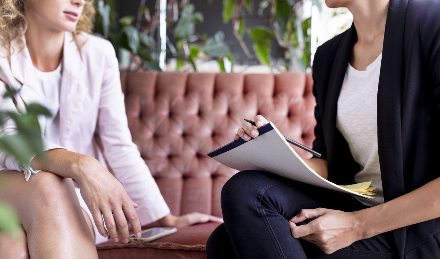 Woman talking with her psychiatrist about a possible renewed mental health diagnosis.