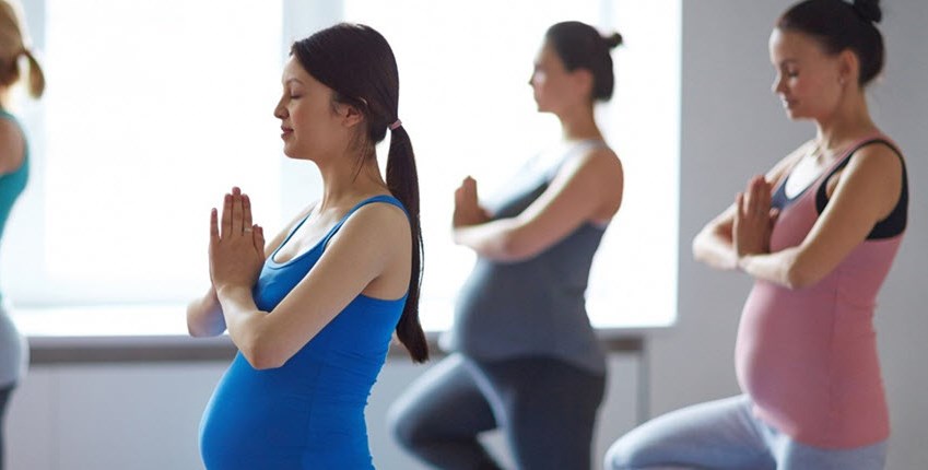 Woman with asthma enjoying a Pregnancy Yoga group exercise class