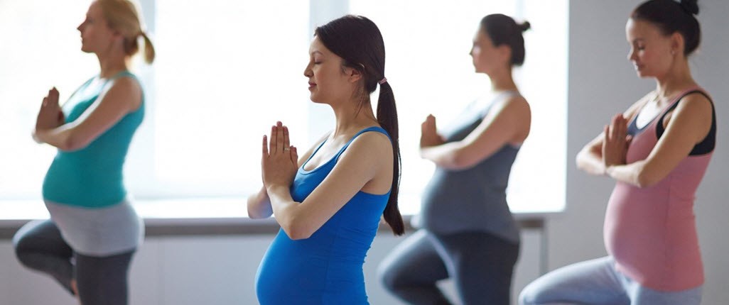 Woman with asthma enjoying a Pregnancy Yoga group exercise class