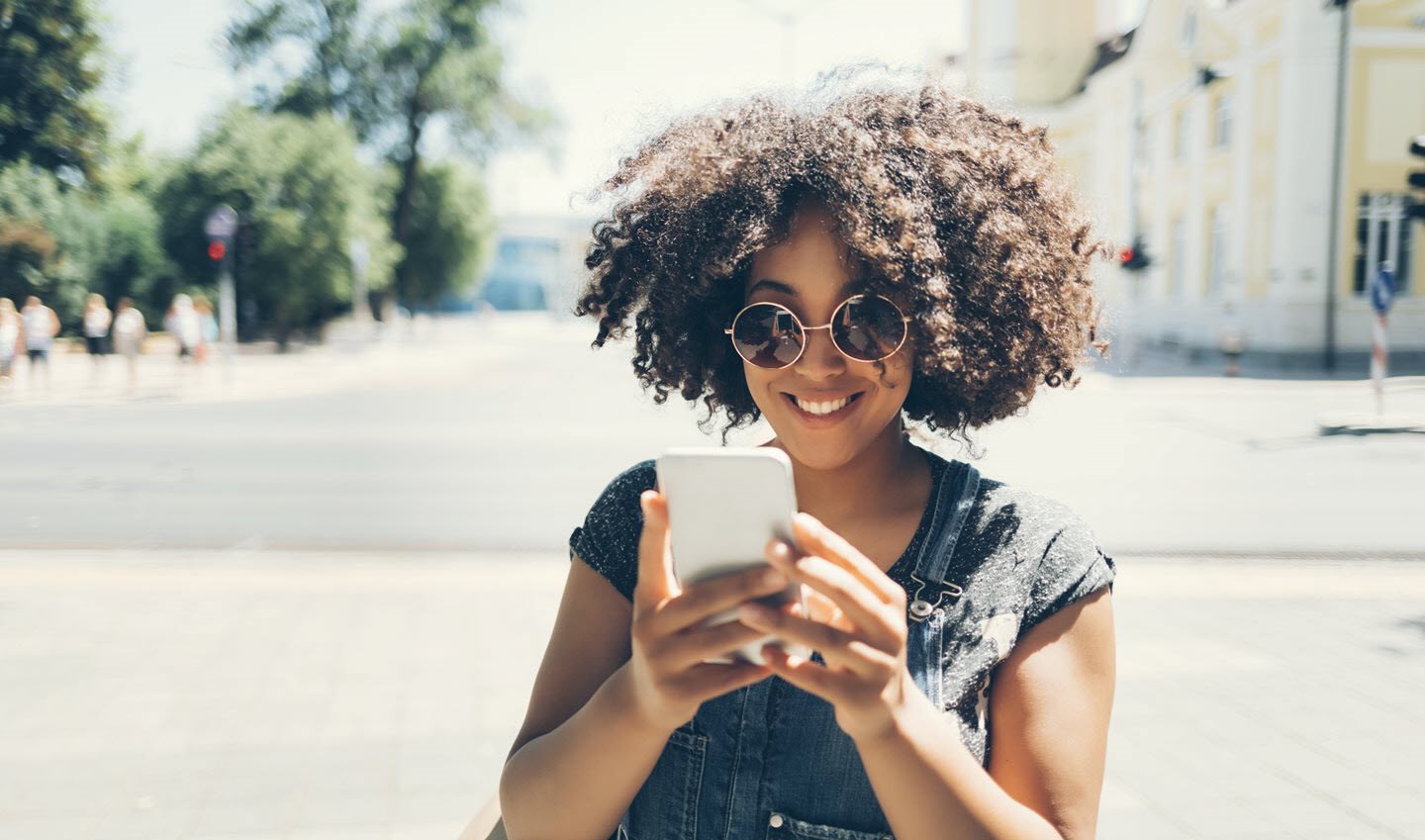 Young woman looking at asthma influencers on her mobile phone.