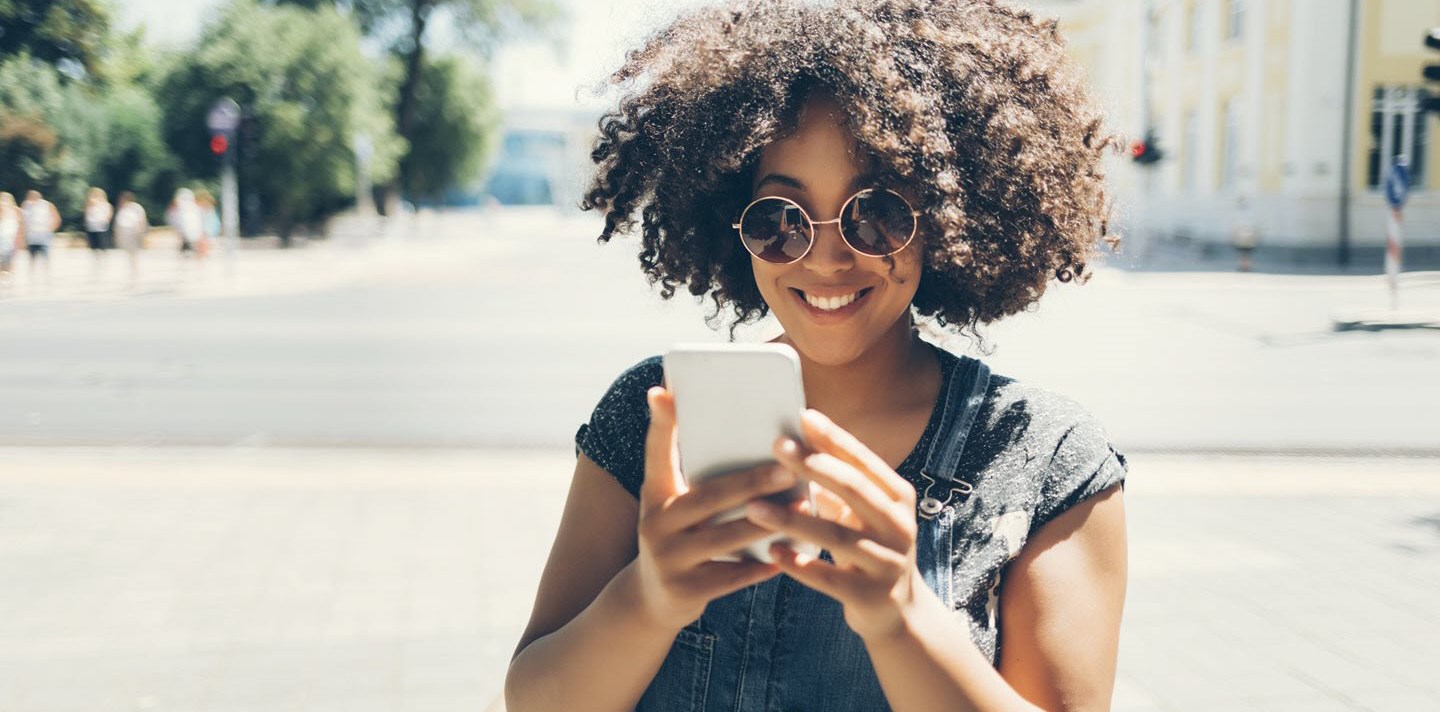 Young woman looking at asthma influencers on her mobile phone.