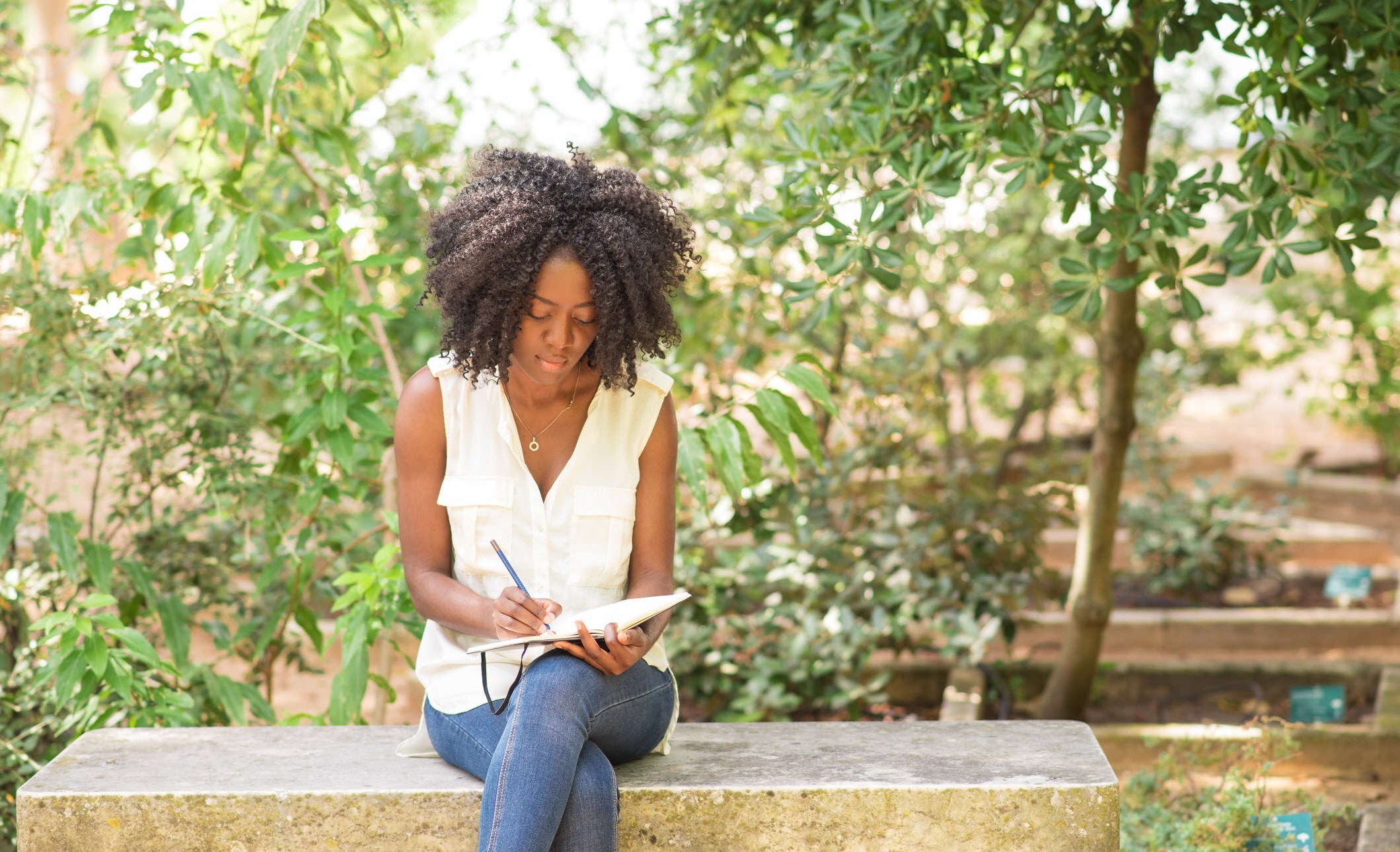 African American woman writting in a journal