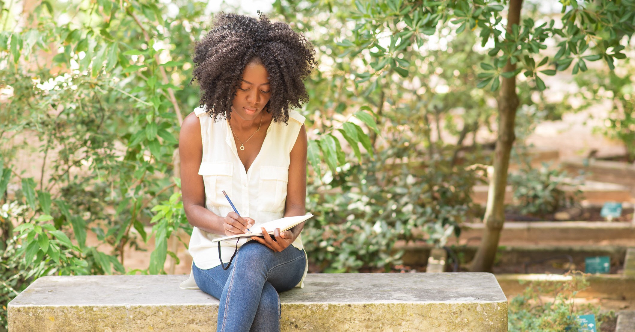 African American woman writting in a journal