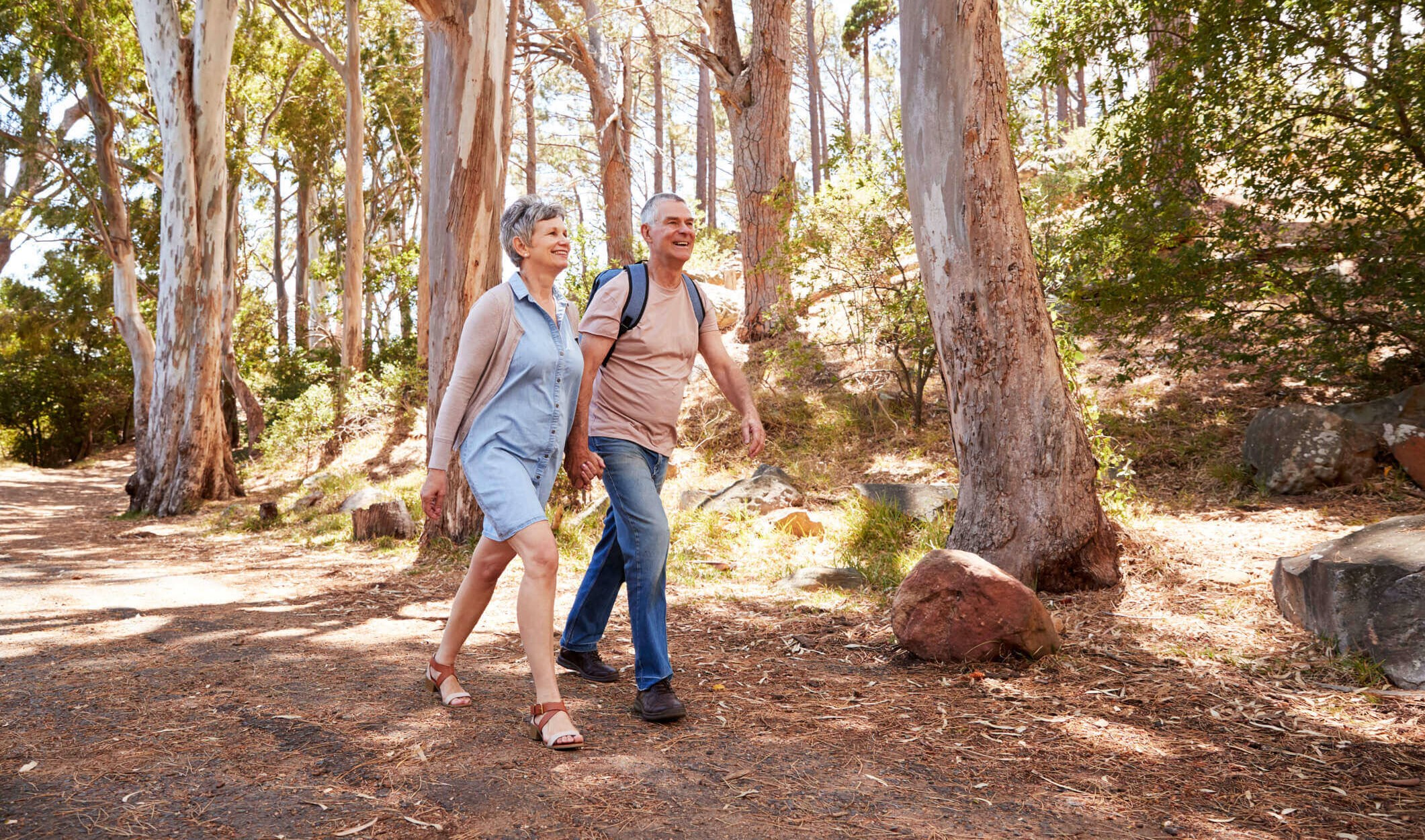 Middle-aged couple with COPD walking in the woods to keep fit and healthy