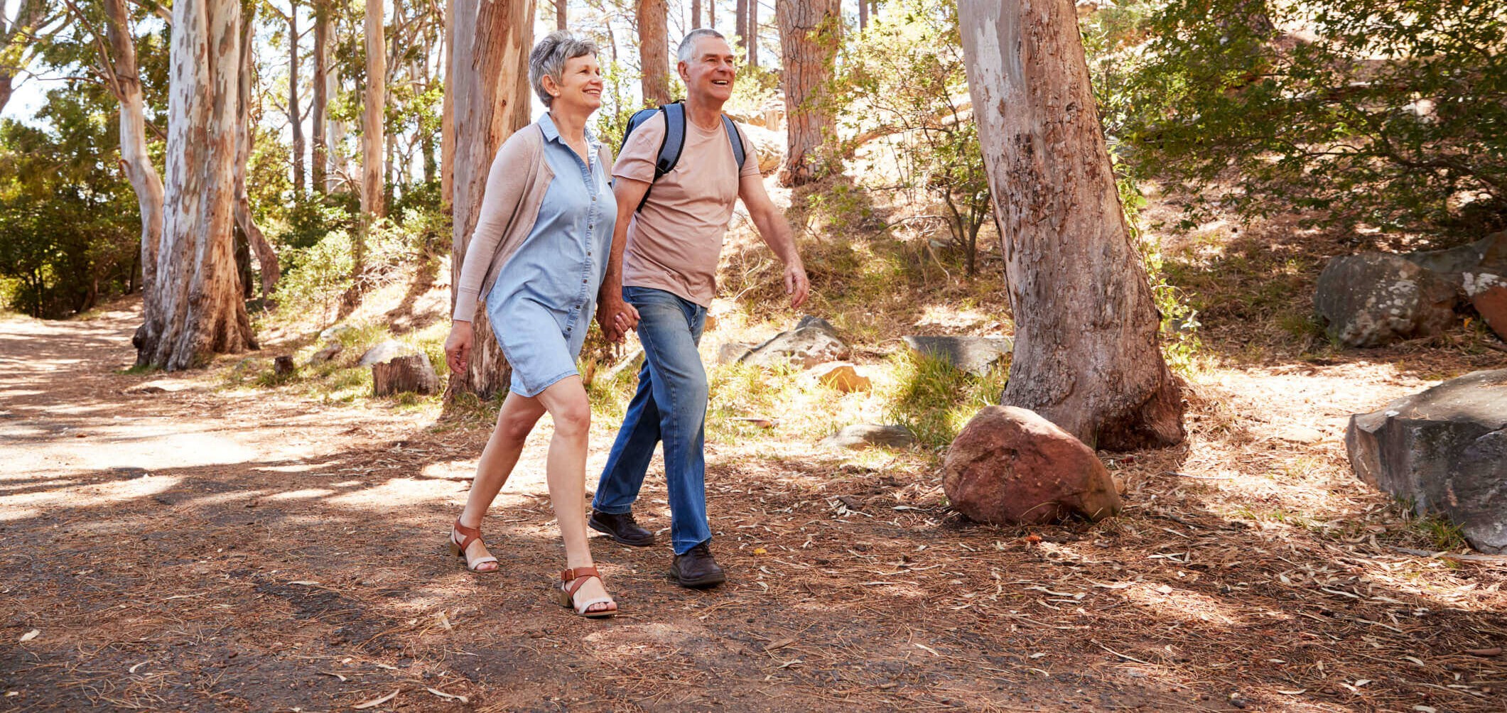 Middle-aged couple with COPD walking in the woods to keep fit and healthy