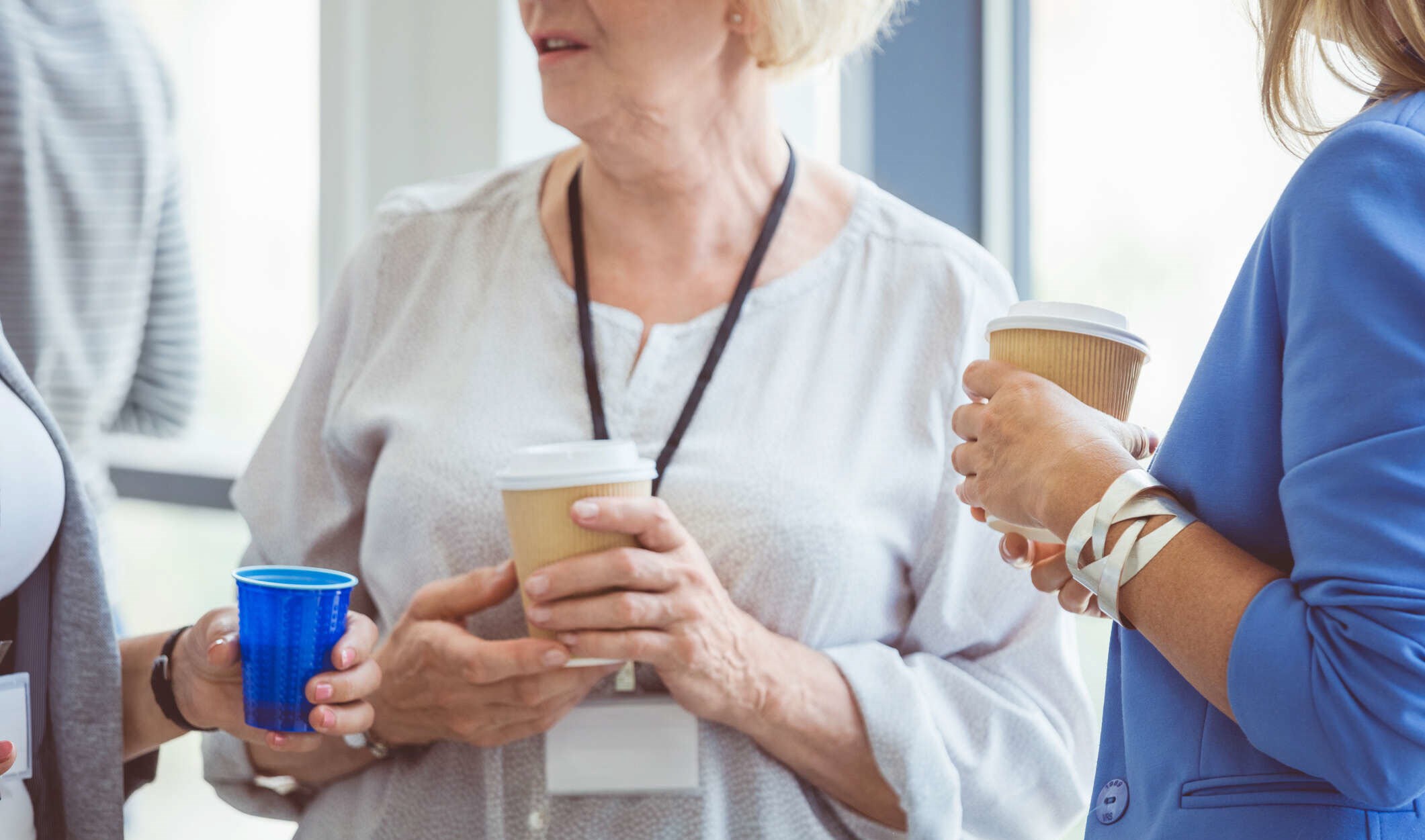 Woman having coffee with colleagues and informing them of her COPD diagnosis.