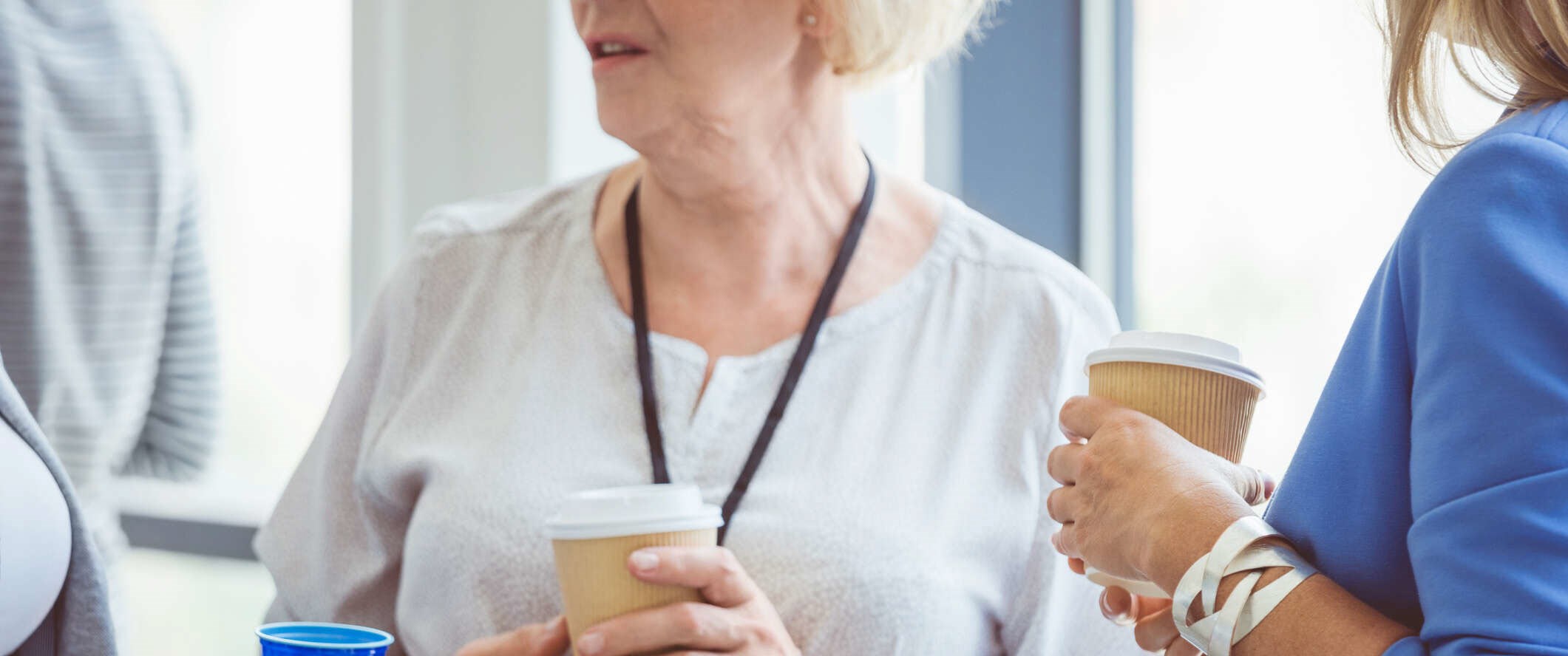 Woman having coffee with colleagues and informing them of her COPD diagnosis.