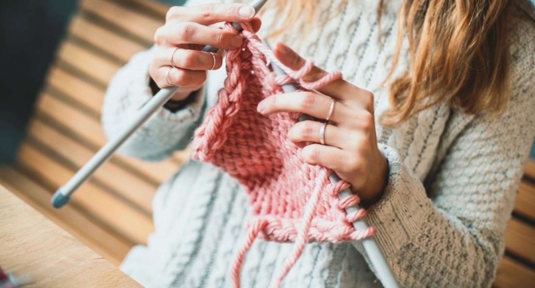 Woman knitting as a distraction from migraine pain 